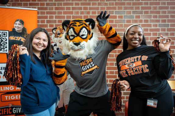 students with powercat holding pompoms